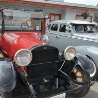Retro vehicles displayed outside 2400 Motel bungalows