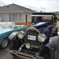 Retro vehicles displayed outside 2400 Motel bungalows